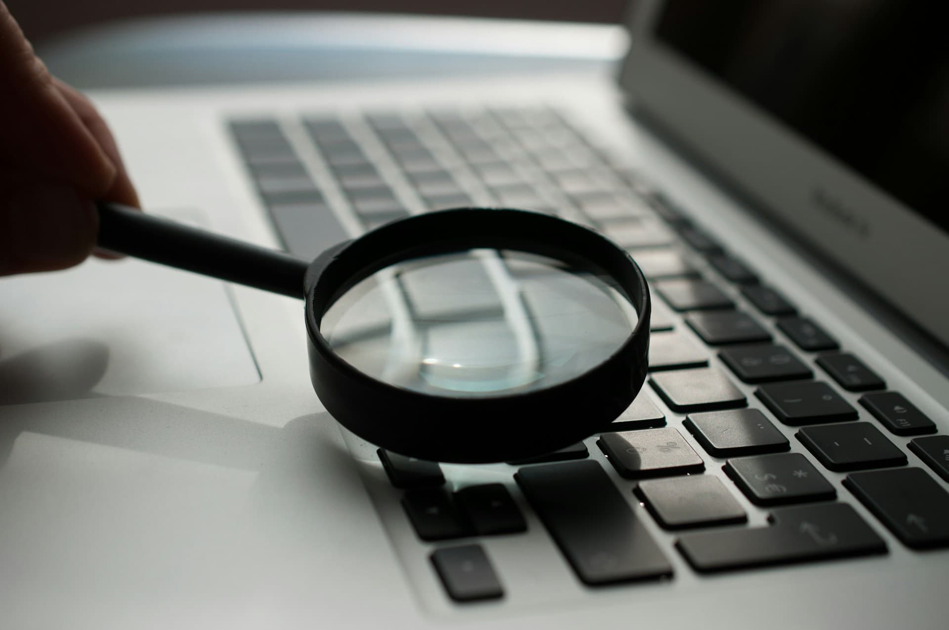 Person using a laptop to research opportunities and improve professional visibility